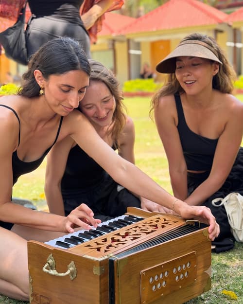 Musicians gathered around Just Prem harmoniums